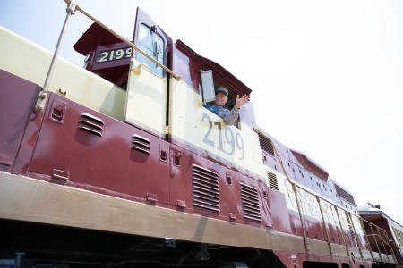 Train Conductor waiving on train