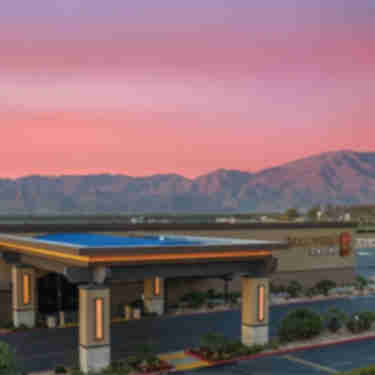 Augustine Casino exterior photo with sunset behind.