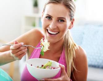 Woman eating salad