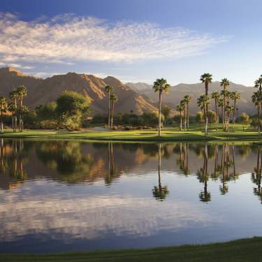 Indian Wells Golf Resort Trees Reflecting On A Pond With Mountains In The Back Ground