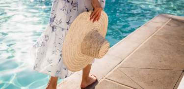 sun hat walking through the ritz carlton pool