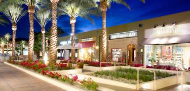 Shopping district and palm trees at dusk