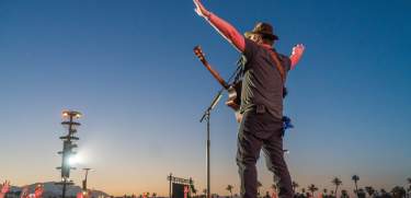 Country music star singing to large crowd at Stagecoach Music Festival.