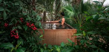 Woman relaxing in hot mineral pool at Two Bunch Palms resort in Desert Hot Springs