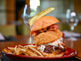 Hamburger with onion ring and pickle from VUE Grille & Bar