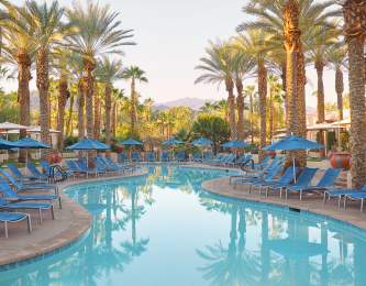 Pool surrounded by palm trees at Hyatt Regency Indian Wells