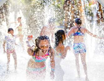 Children play in a splash pad at Hyatt Regency Indian Wells Resort & Spa.