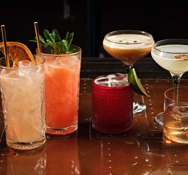 Various cocktails are lined up on a table at El Jefe at Saguaro in Palm Springs.