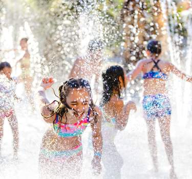 Children play in a splash pad at Hyatt Regency Indian Wells Resort & Spa.