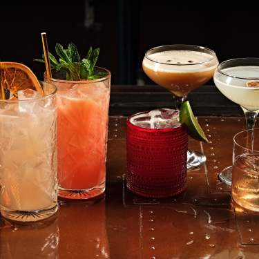 Various cocktails are lined up on a table at El Jefe at Saguaro in Palm Springs.