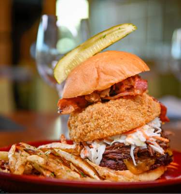 Hamburger with onion ring and pickle from VUE Grille & Bar