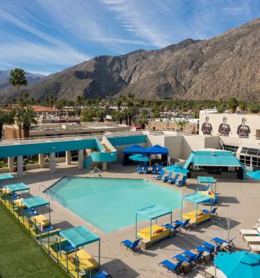 View Of The Pool With Mountains In The Background At Hotel ZOSO In Palm Springs