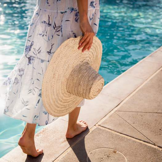 sun hat walking through the ritz carlton pool