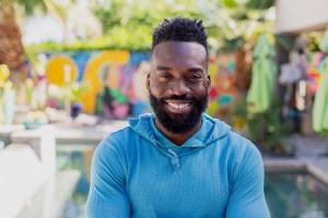 Artist Tysen Knight photographed in front of a mural he painted at a private residence in Rancho Mirage
