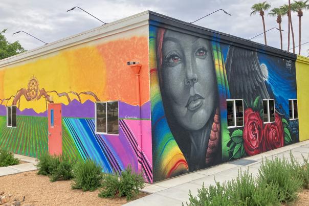 Three different colorful murals are painted on the sides of two walls at Coachella City Hall.