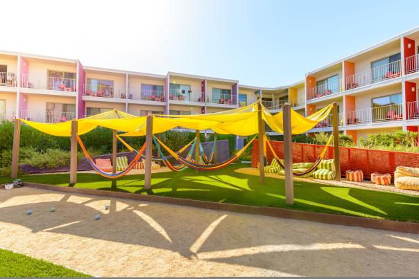 A series of hammocks underneath a shade canopy at Hammock Village at The Saguaro.