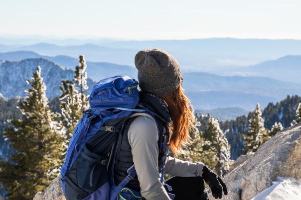 Female hiker admiring the snowy view from San Jacinto Peak