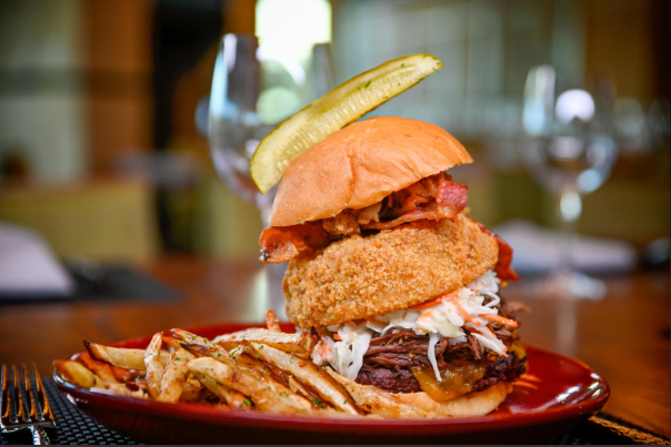 Hamburger with onion ring and pickle from VUE Grille & Bar