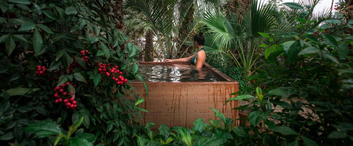 Woman relaxing in hot mineral pool at Two Bunch Palms resort in Desert Hot Springs