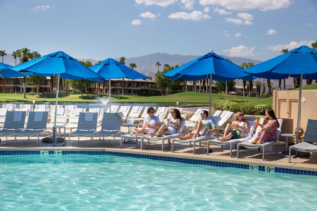 Friends lounging poolside at the JW Marriott Desert Springs