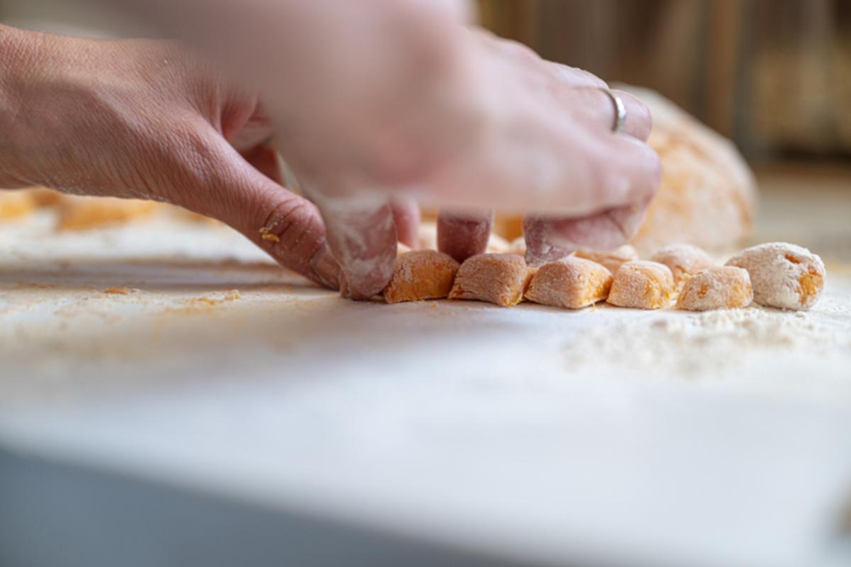 Someone rolling dough in a cooking class
