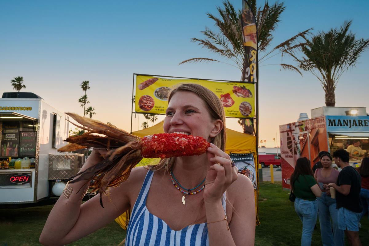Girl eating corn at Food Truck Fridays in Indio