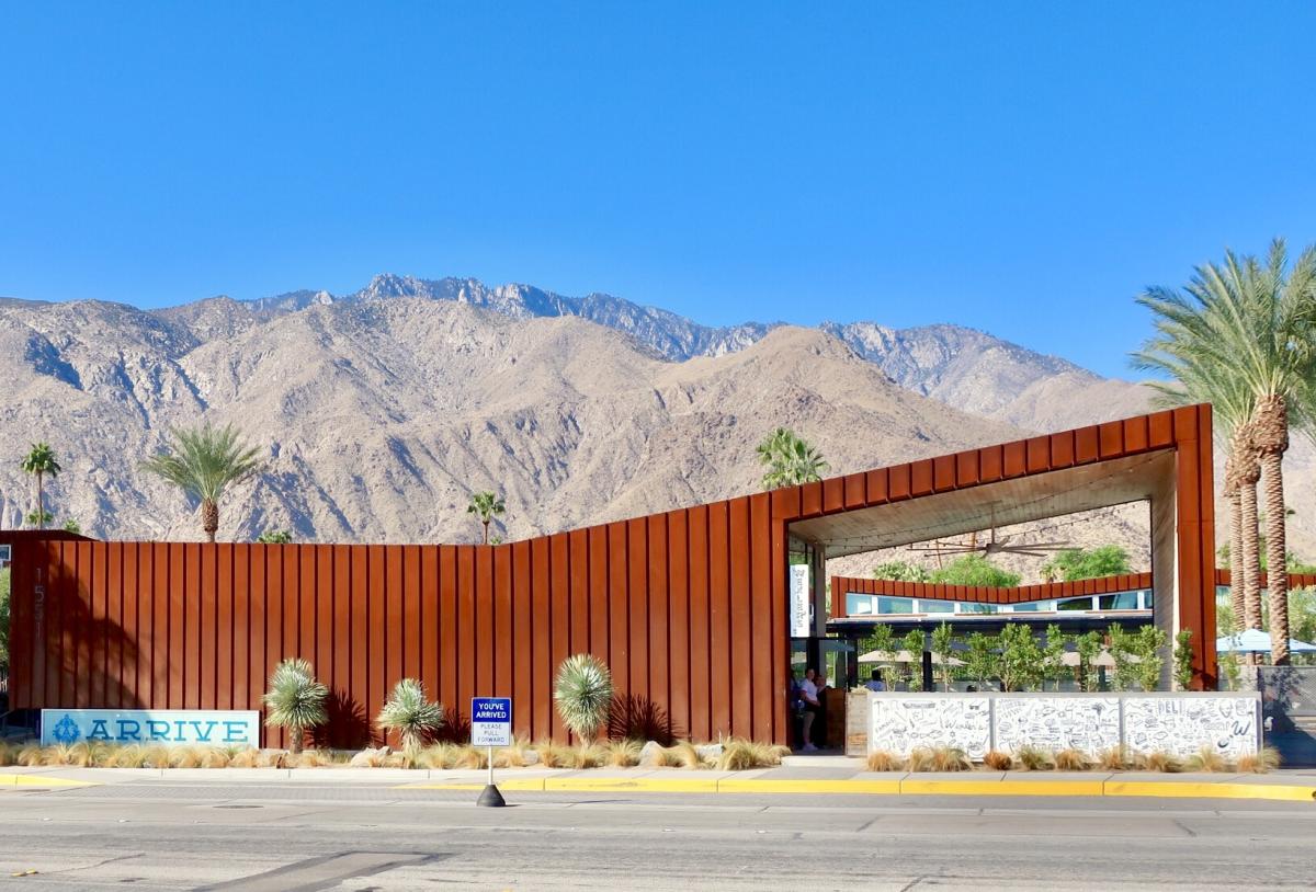 Sunny view of Arrive Hotel with the beautiful mountains in the background.