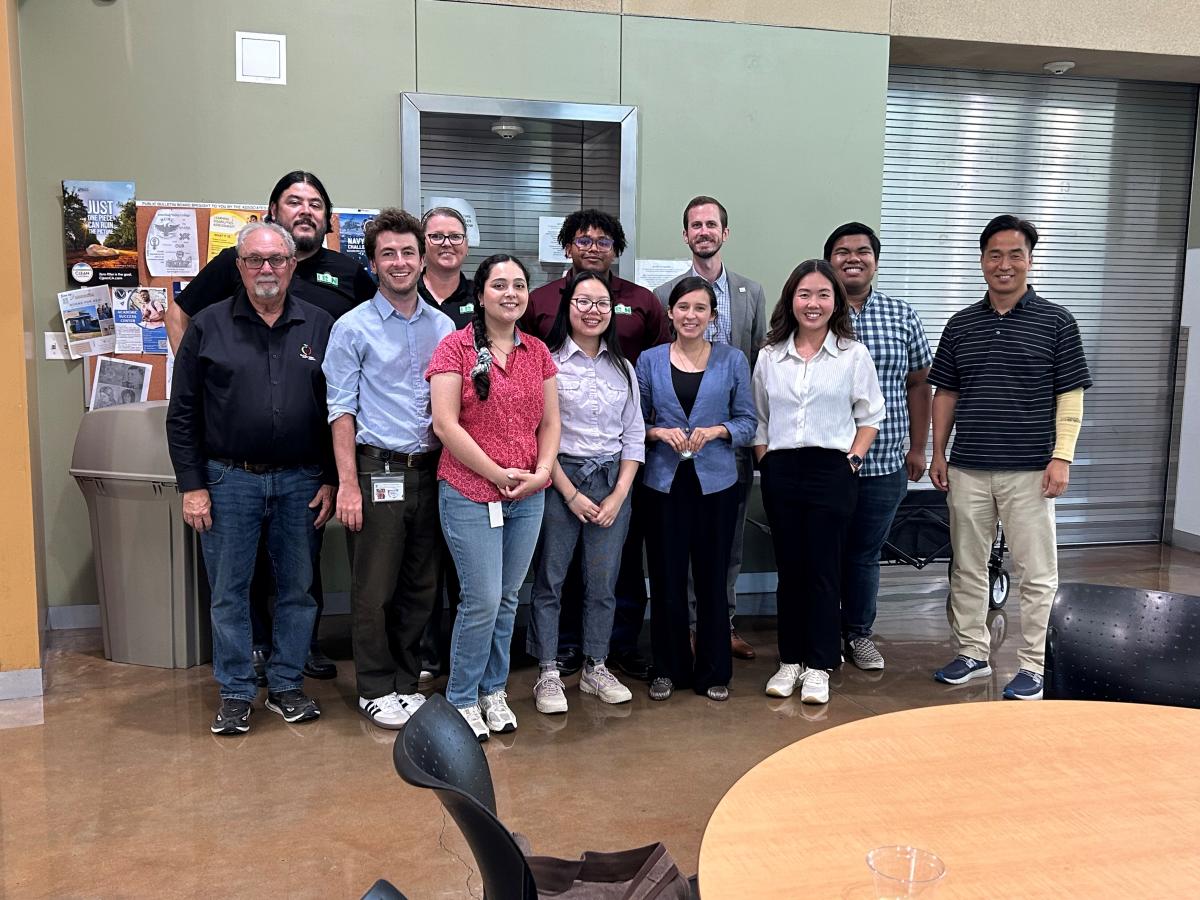 A group of people smile during a tour of the San Bernardino Valley Community College.