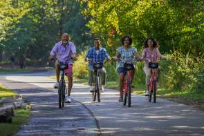 Family riding bikes on the Prisma Health Swamp Rabbit Trail Network