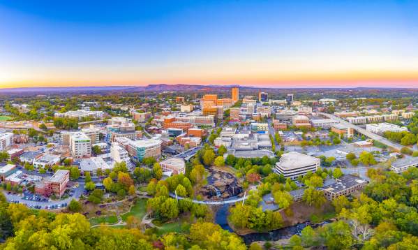 The Greenville Downtown Skyline at dusk shows the close proximity to the beauty of the Blue Ridge Mountains
