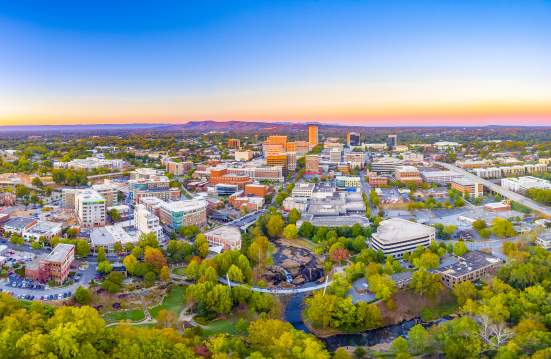 The Greenville Downtown Skyline at dusk shows the close proximity to the beauty of the Blue Ridge Mountains