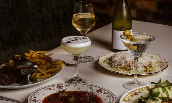 Several plated dishes and cocktails at Scoundrel