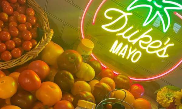 Duke's Mayo jars sit atop tomatoes of all kinds at