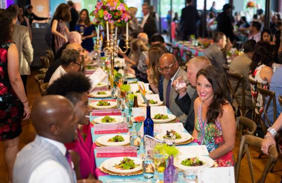 Group of attendees dining at La Fiesta event at Huguenot Loft in 2019