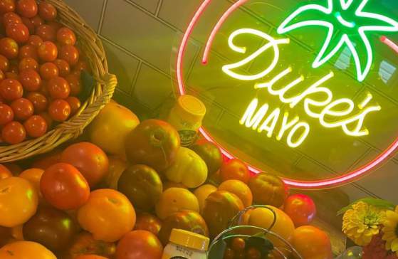 Duke's Mayo jars sit atop tomatoes of all kinds at