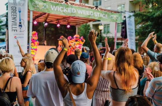 Crowd listening to performers on the Wicked Weed Stage in Fall for Greenville
