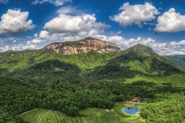 Aerial view of Table Rock State Park and the surrounding mountains and trees on a sunny day