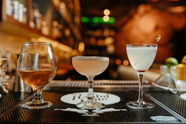 Three cocktails sit atop the bar at The Rabbit Hole in downtown Greenville, SC.