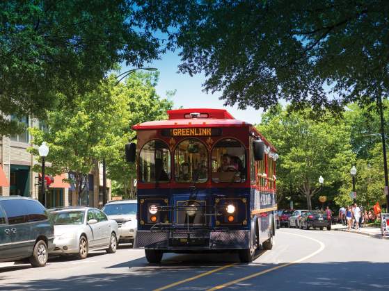 Free trolley moving through Greenville's Main Street.