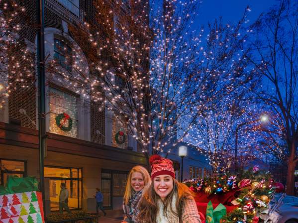 People riding in a Christmas Carriage Downtown
