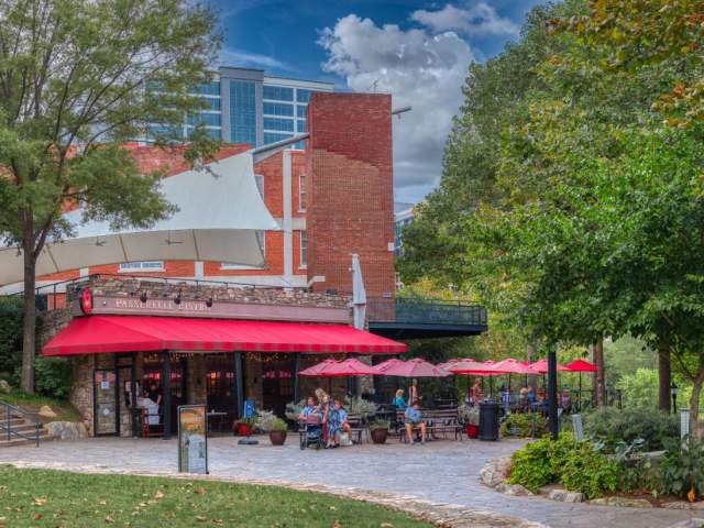Patrons enjoying a meal at Passerelle Bistro, at the entrance to Falls Park on the Reedy in Greenville, SC.