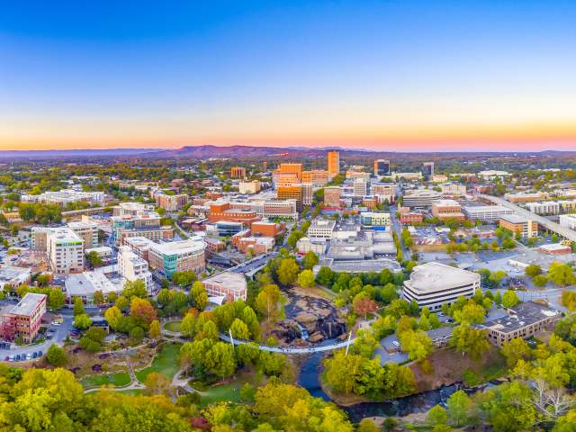 The Greenville Downtown Skyline at dusk shows the close proximity to the beauty of the Blue Ridge Mountains
