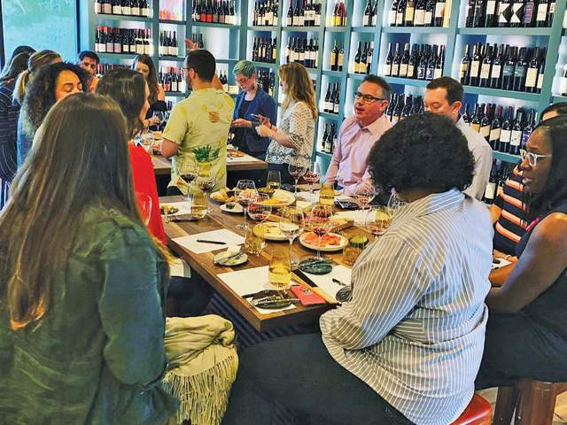 People enjoying food and drinks from the Wine House