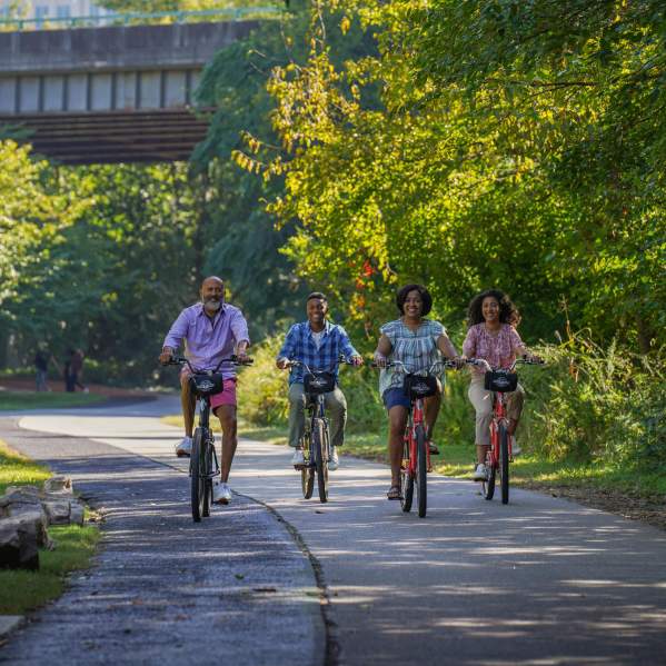 Family riding bikes on the Prisma Health Swamp Rabbit Trail Network