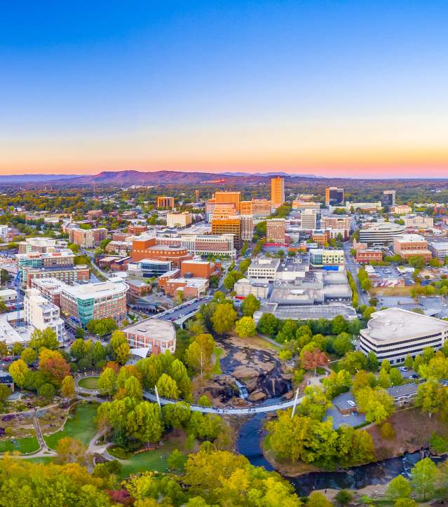 The Greenville Downtown Skyline at dusk shows the close proximity to the beauty of the Blue Ridge Mountains