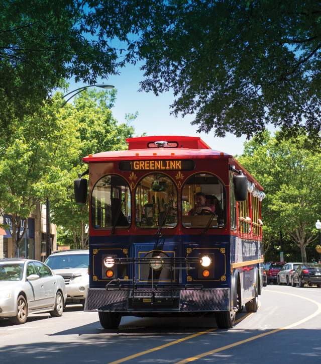 Free trolley moving through Greenville's Main Street.