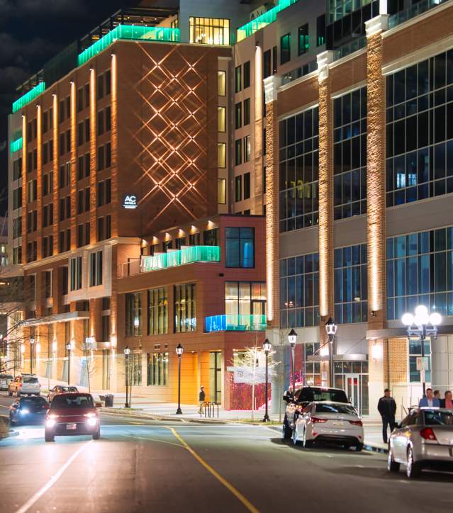 The brand new AC Hotel is lit up next to the Bank of America and Camperdown Plaza; as seen from the Main Street Bridge.