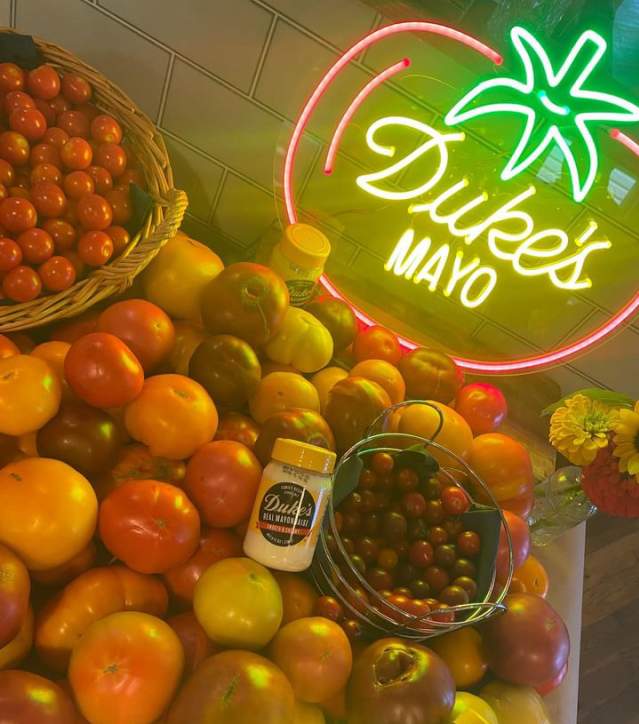 Duke's Mayo jars sit atop tomatoes of all kinds at