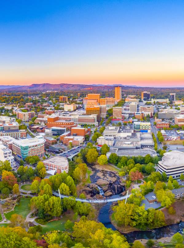 The Greenville Downtown Skyline at dusk shows the close proximity to the beauty of the Blue Ridge Mountains