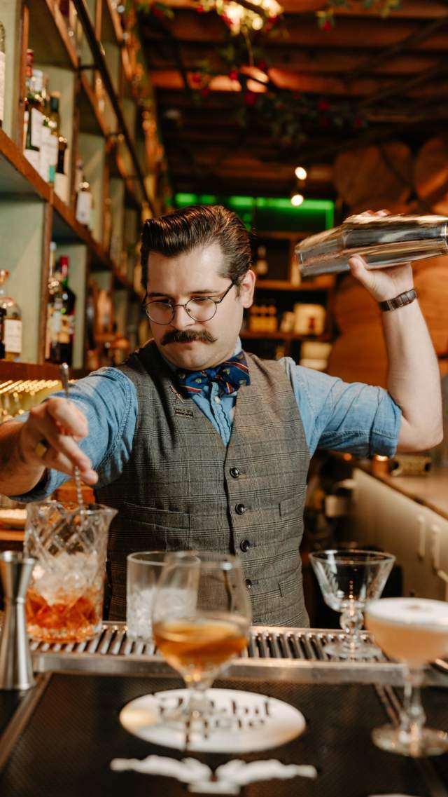 Colin, the bartender at The Rabbit Hole in the Village of West Greenville, SC, mixes up cocktails.